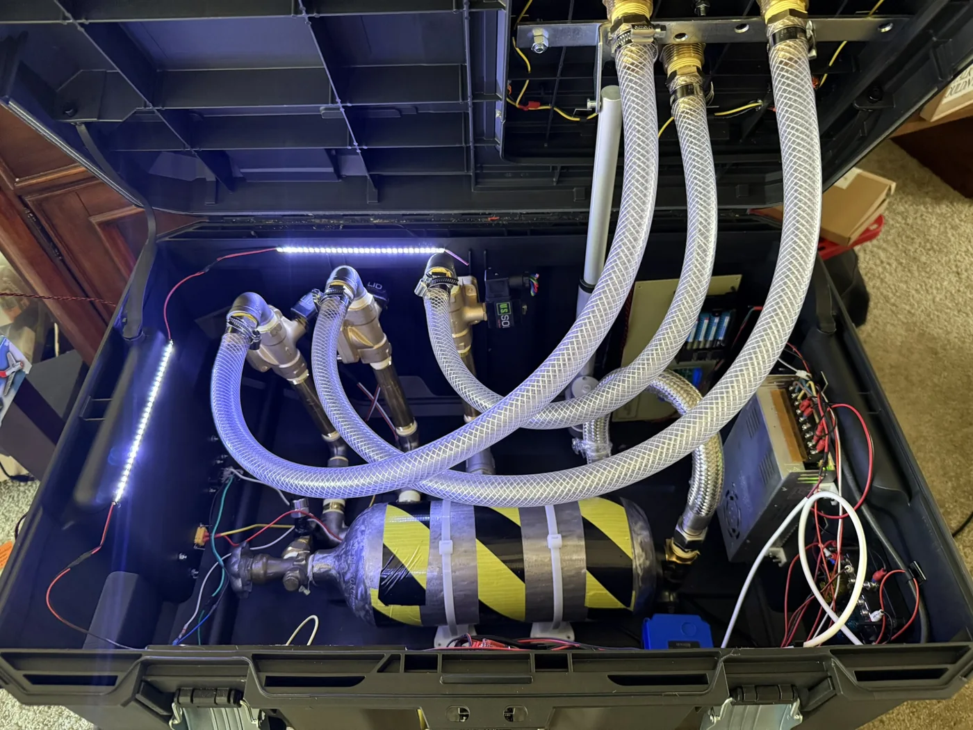 Inside the cannon case: air tank, three solenoid valves, braided hoses, power supply, and wiring